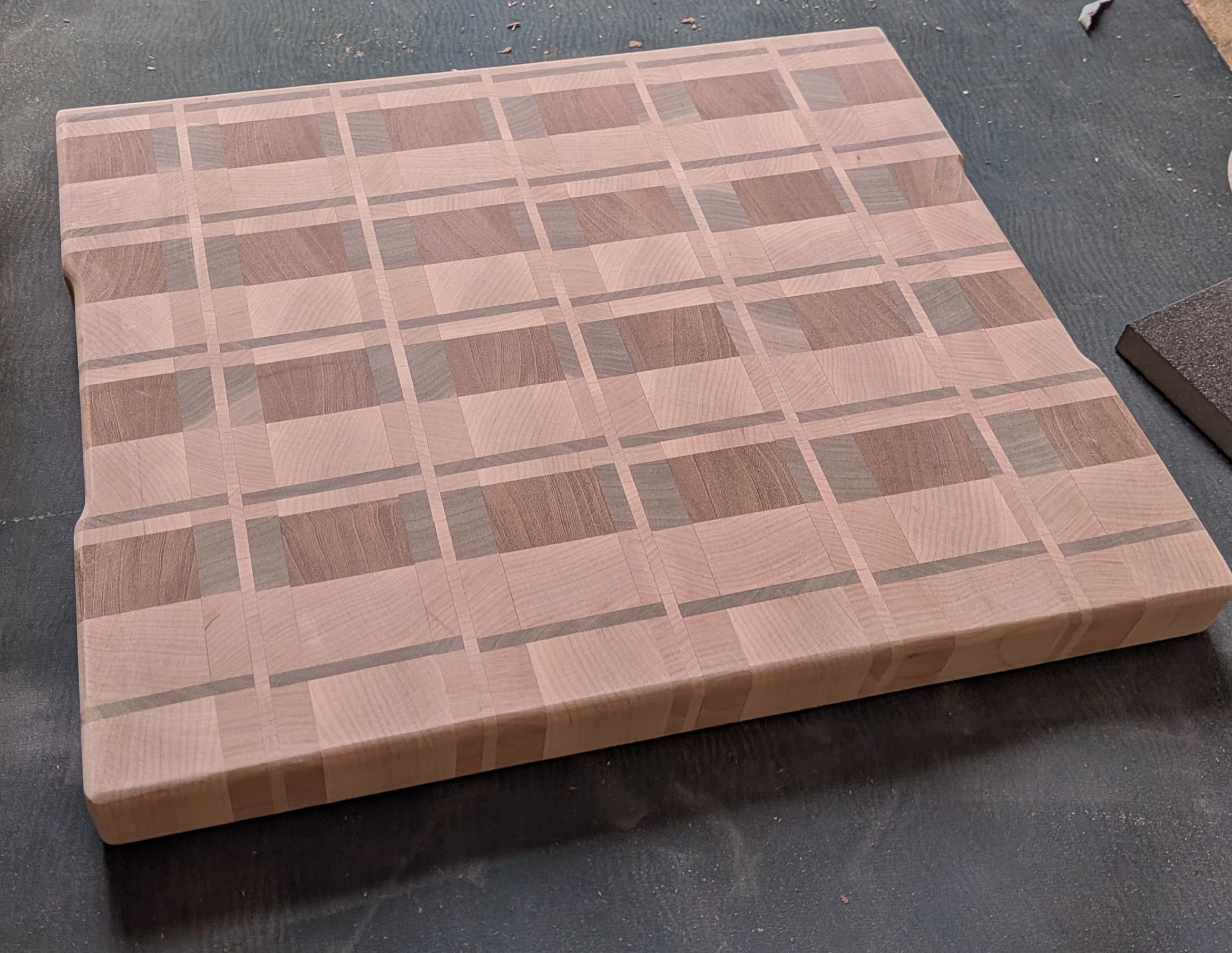 End-grain cutting board in a maple and walnut plaid pattern